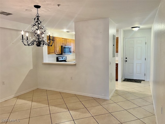 interior space with light tile patterned floors and a chandelier