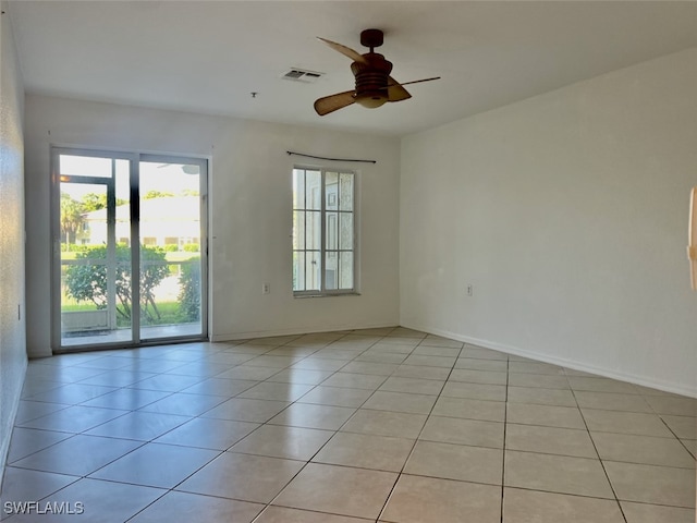 tiled empty room with ceiling fan