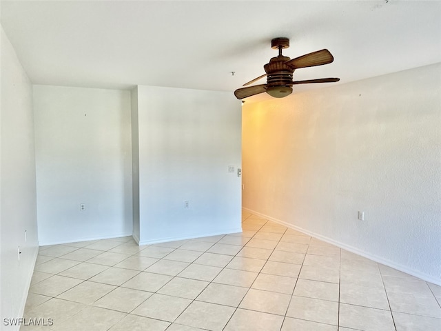 tiled empty room featuring ceiling fan