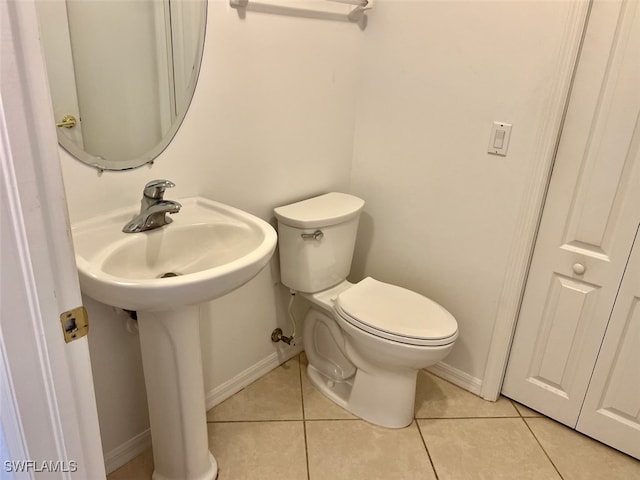 bathroom with tile patterned flooring and toilet