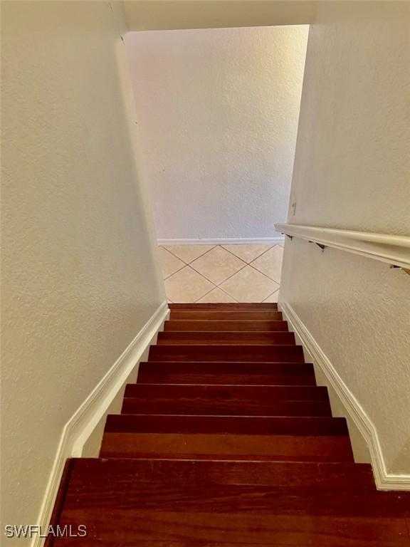 stairs featuring wood-type flooring