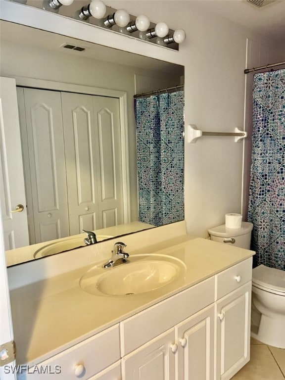 bathroom featuring vanity, toilet, and tile patterned floors