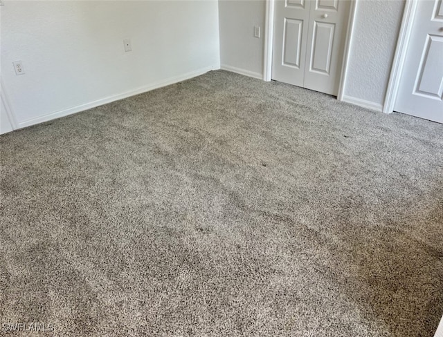 unfurnished bedroom with a closet and carpet flooring