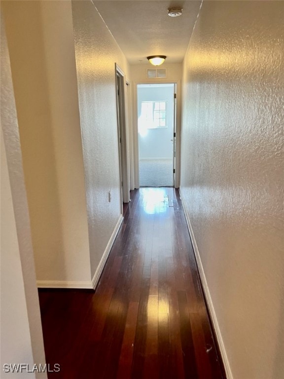 hall with dark wood-type flooring