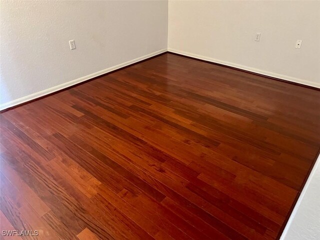 spare room with hardwood / wood-style floors