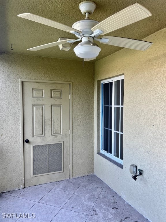 entrance to property featuring ceiling fan