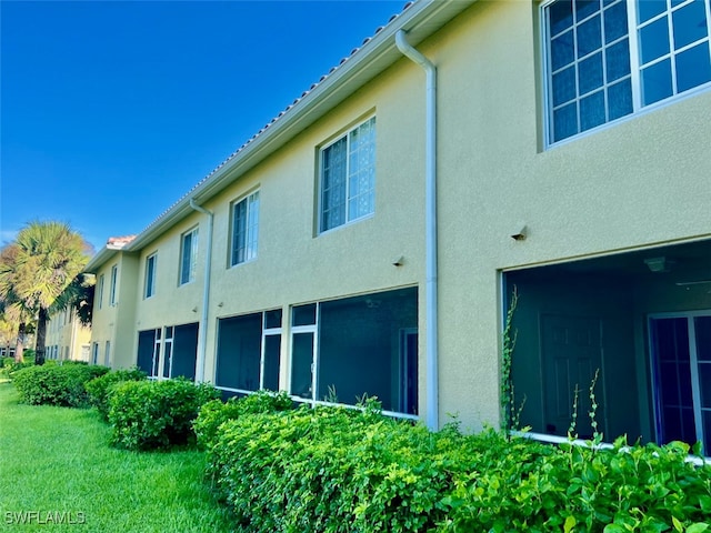 view of side of home with a yard