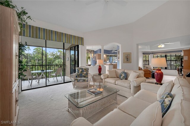 27026 Oakwood Lake Dr Unit 202, Bonita Springs, FL 34134 - living area featuring vaulted ceiling, ceiling fan, arched walkways, carpet flooring, and ornate columns