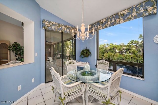 27026 Oakwood Lake Dr Unit 202, Bonita Springs, FL 34134 - tiled dining area featuring vaulted ceiling, baseboards, and a chandelier