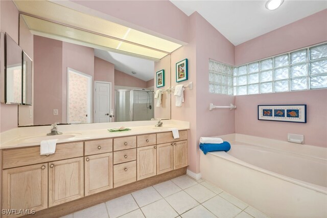 bathroom with vanity, lofted ceiling, shower with separate bathtub, and tile patterned flooring