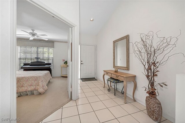 interior space featuring light carpet and ceiling fan