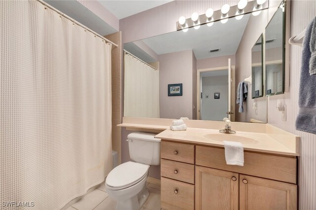 full bathroom with vanity, toilet, tile patterned floors, and shower / bath combo with shower curtain