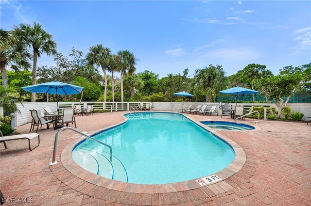 view of pool with a patio area and a community hot tub