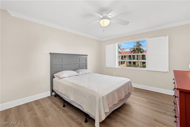 bedroom with ceiling fan, light hardwood / wood-style flooring, and ornamental molding