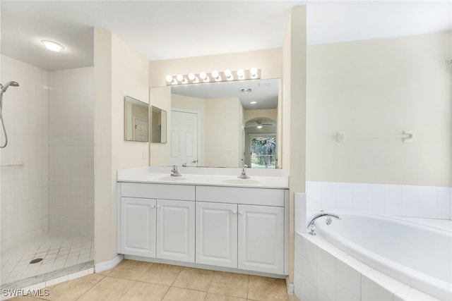 bathroom with independent shower and bath, vanity, and tile patterned floors