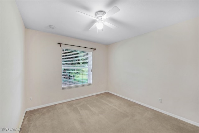 empty room featuring light carpet and ceiling fan