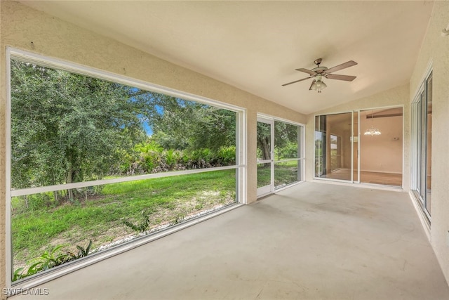 unfurnished sunroom with ceiling fan and vaulted ceiling