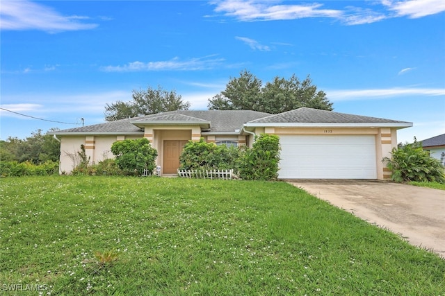 single story home with a garage and a front lawn