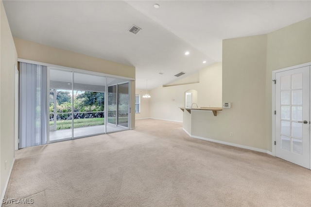 unfurnished living room featuring carpet flooring and lofted ceiling