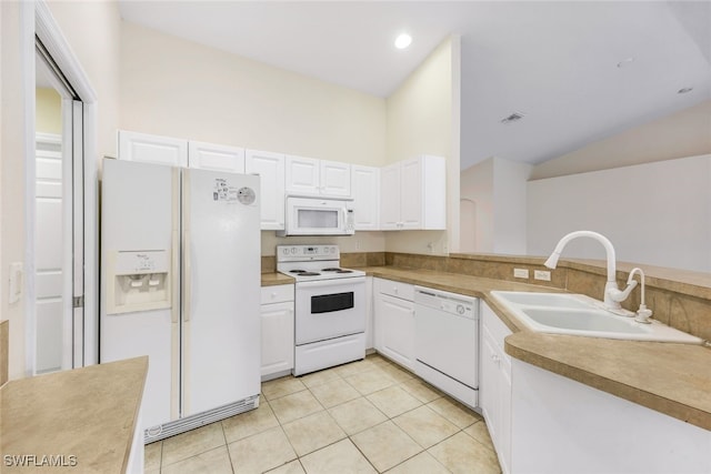 kitchen with white cabinets, light tile patterned floors, sink, white appliances, and vaulted ceiling