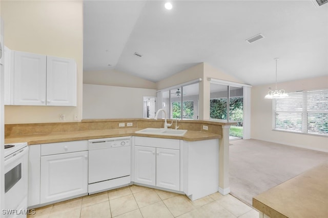 kitchen with sink, white appliances, white cabinetry, light carpet, and vaulted ceiling