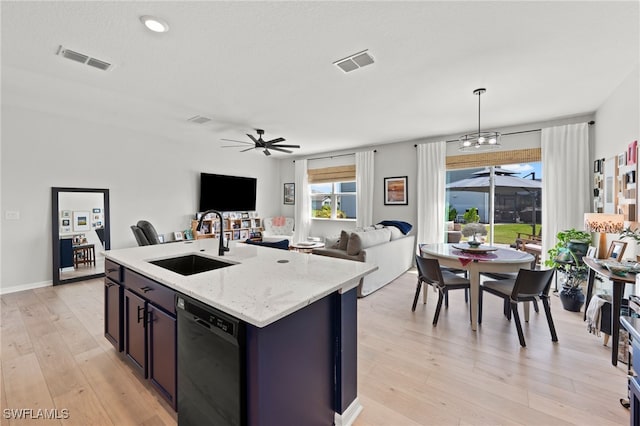 kitchen with black dishwasher, sink, hanging light fixtures, a center island with sink, and ceiling fan