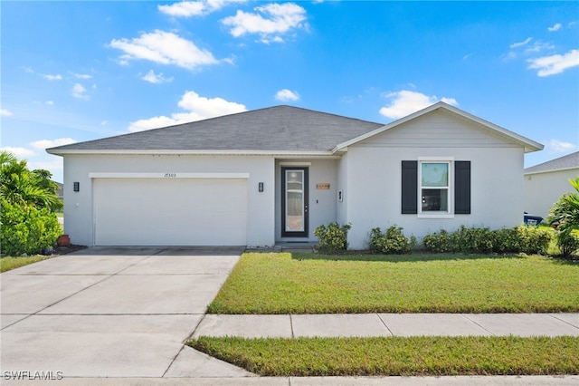 single story home featuring a garage and a front lawn