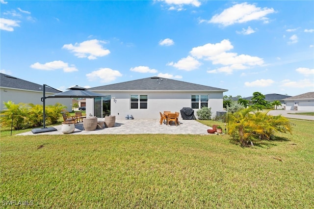 rear view of house with a gazebo, a lawn, and a patio area