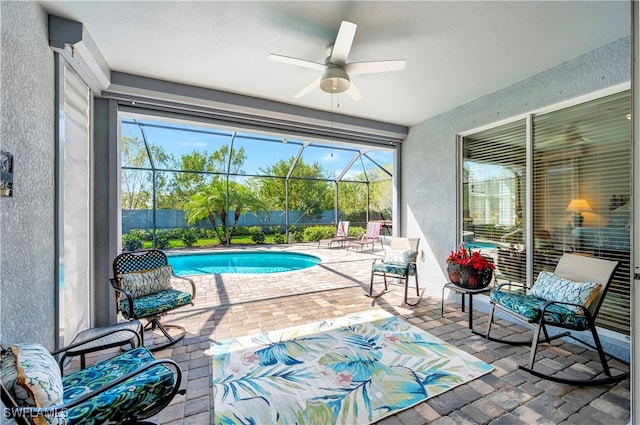 interior space featuring ceiling fan, a pool, and a wealth of natural light