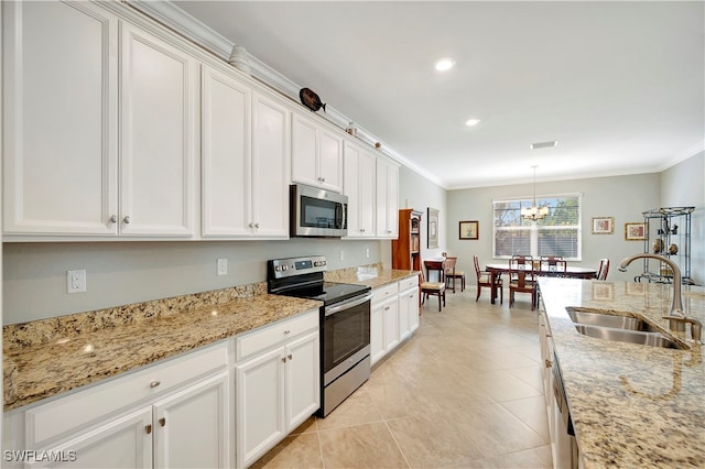 kitchen with white cabinets, sink, stainless steel appliances, and ornamental molding