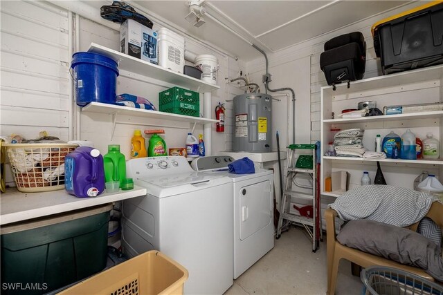 washroom featuring washing machine and dryer and electric water heater