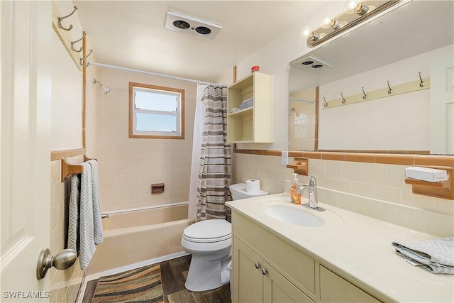 full bathroom with shower / bath combo, wood-type flooring, toilet, vanity, and tile walls