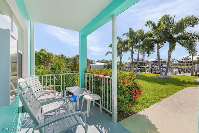 balcony featuring a porch and a water view