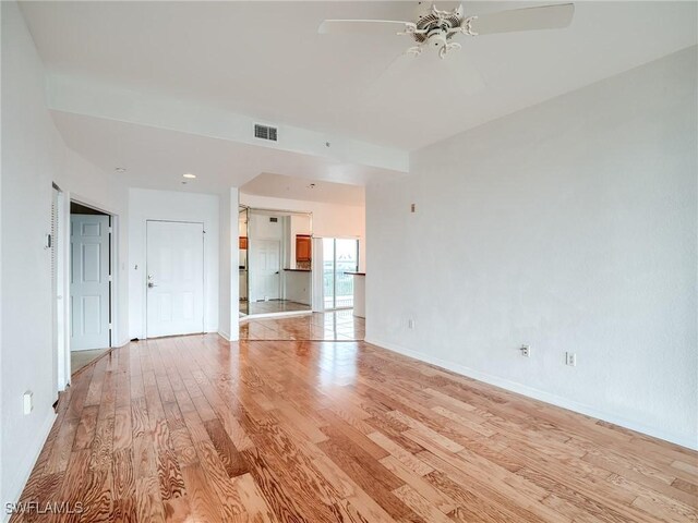 unfurnished living room featuring ceiling fan and light hardwood / wood-style floors