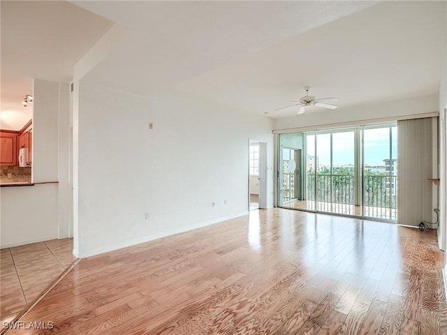 spare room with light wood-type flooring and ceiling fan