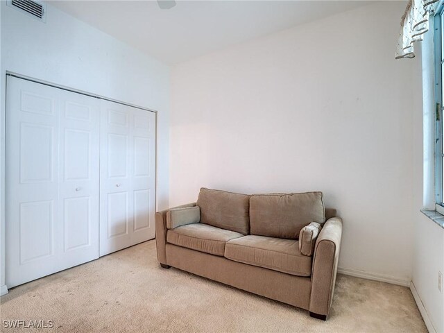 sitting room featuring light carpet