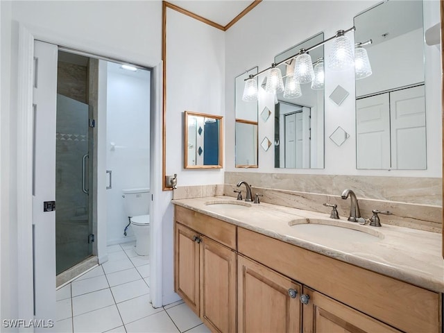 bathroom featuring tile patterned flooring, vanity, toilet, and a shower with shower door