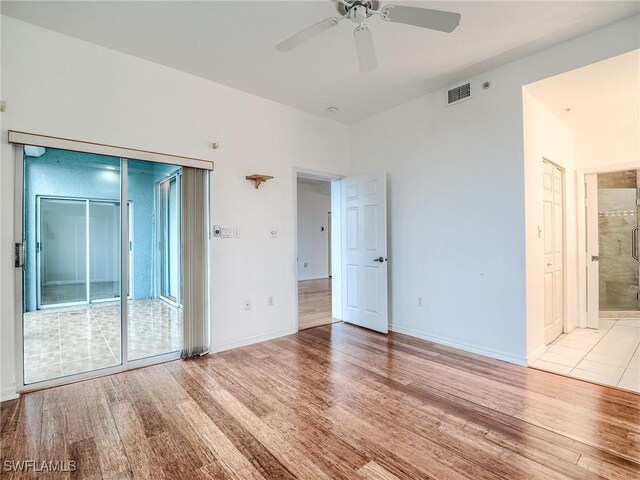 empty room featuring ceiling fan and light wood-type flooring