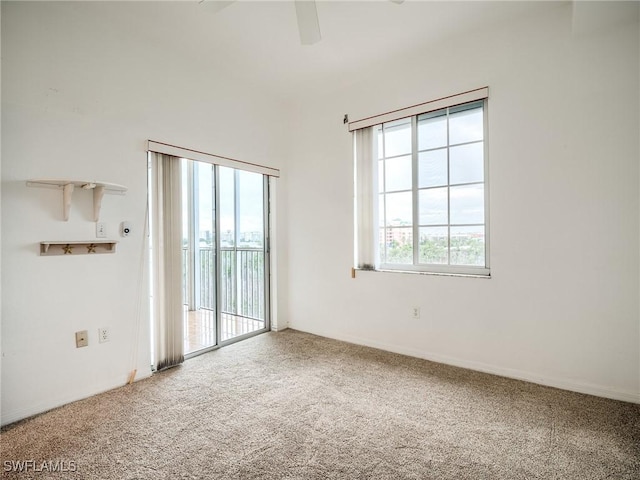 unfurnished room with carpet flooring, plenty of natural light, and ceiling fan