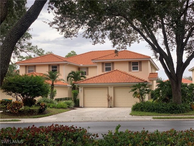 mediterranean / spanish-style house with a garage