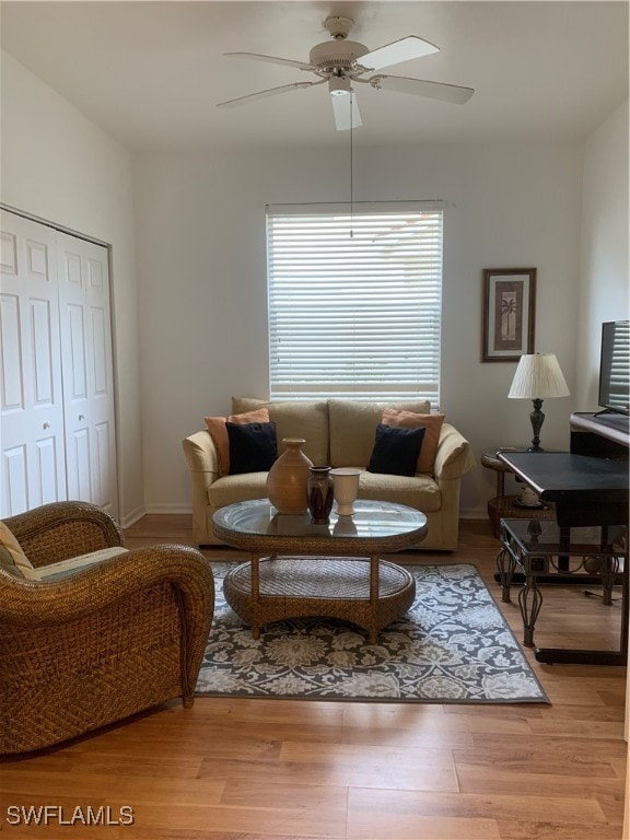 living room featuring hardwood / wood-style flooring and ceiling fan