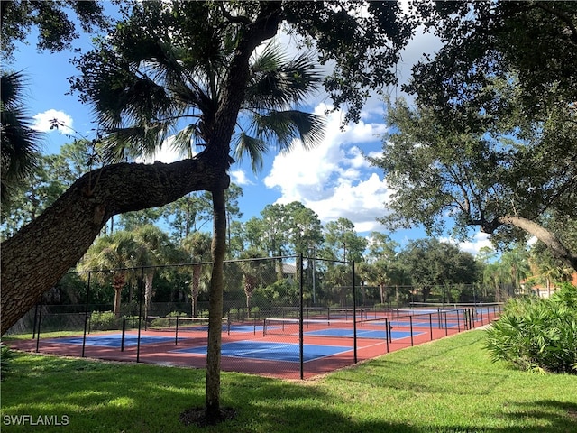 view of sport court with a yard