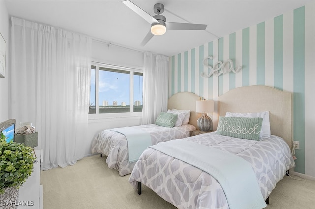 bedroom with ceiling fan and light carpet