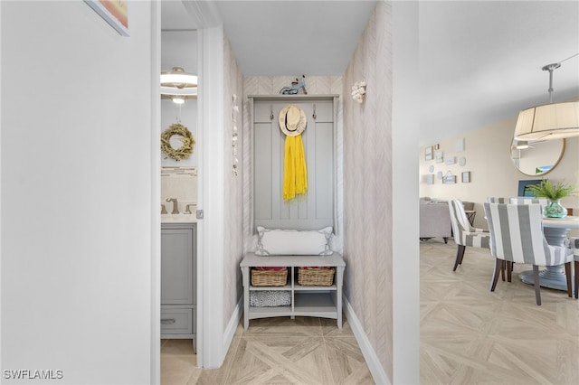 mudroom featuring light parquet floors and sink