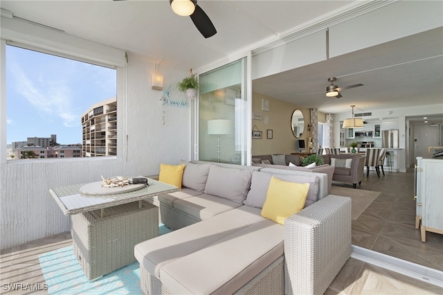 interior space featuring ceiling fan and outdoor lounge area