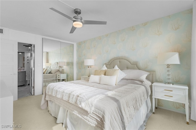 bedroom featuring light carpet and ceiling fan