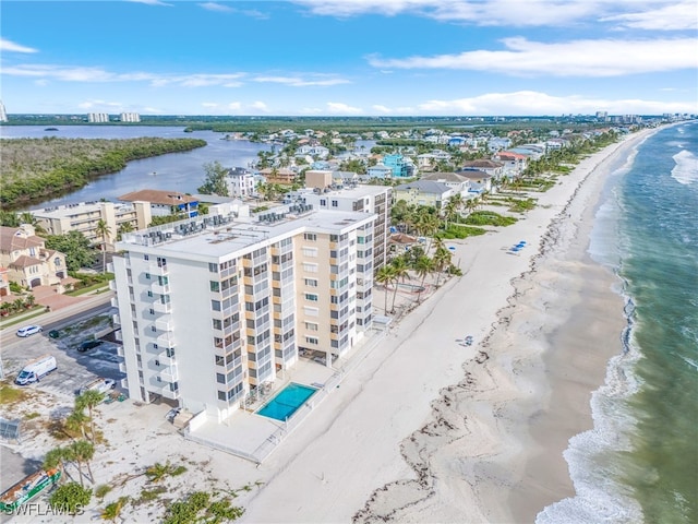 bird's eye view featuring a water view and a beach view