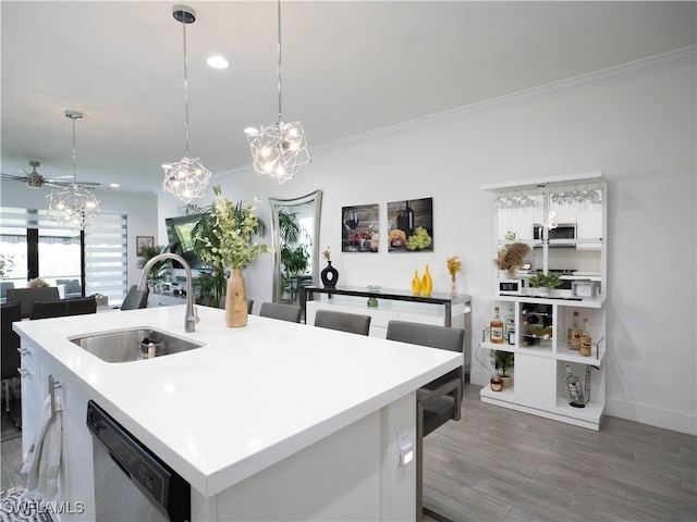 kitchen with dark wood-type flooring, a kitchen island with sink, sink, white cabinetry, and stainless steel dishwasher