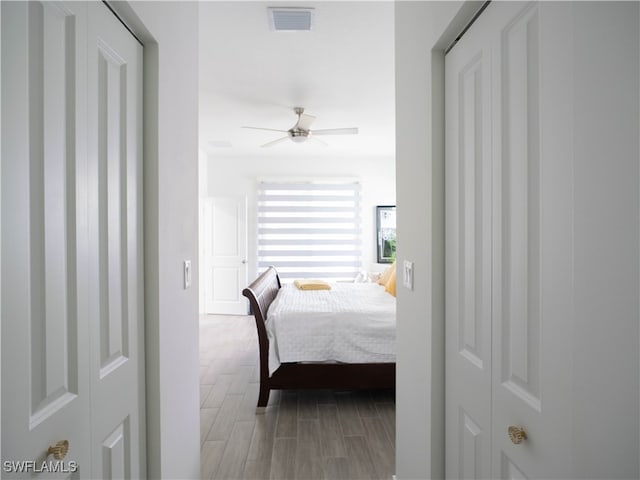 bedroom with ceiling fan and hardwood / wood-style floors