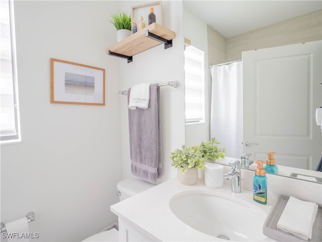 bathroom featuring vanity and toilet